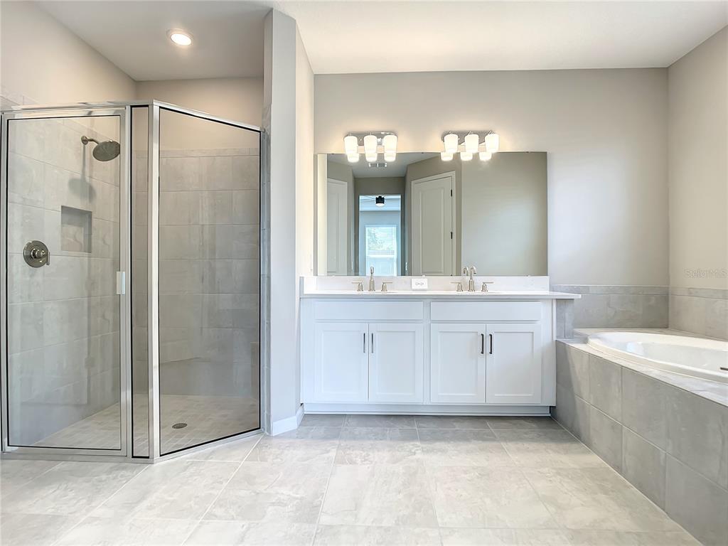 2675 Ridgetop Lane Clermont, FL 34711 - Photo 47 of 56 a bathroom with a double vanity sink mirror and shower