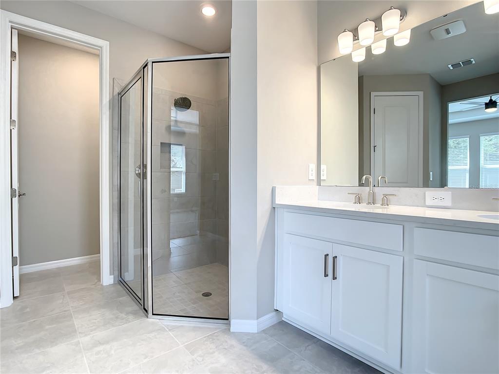 2675 Ridgetop Lane Clermont, FL 34711 - Photo 49 of 56 a bathroom with a double vanity sink and a mirror