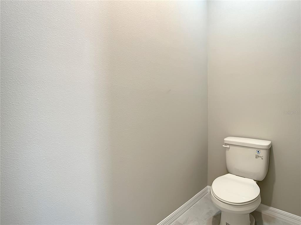 2675 Ridgetop Lane Clermont, FL 34711 - Photo 50 of 56 a white toilet sitting next to a white wall