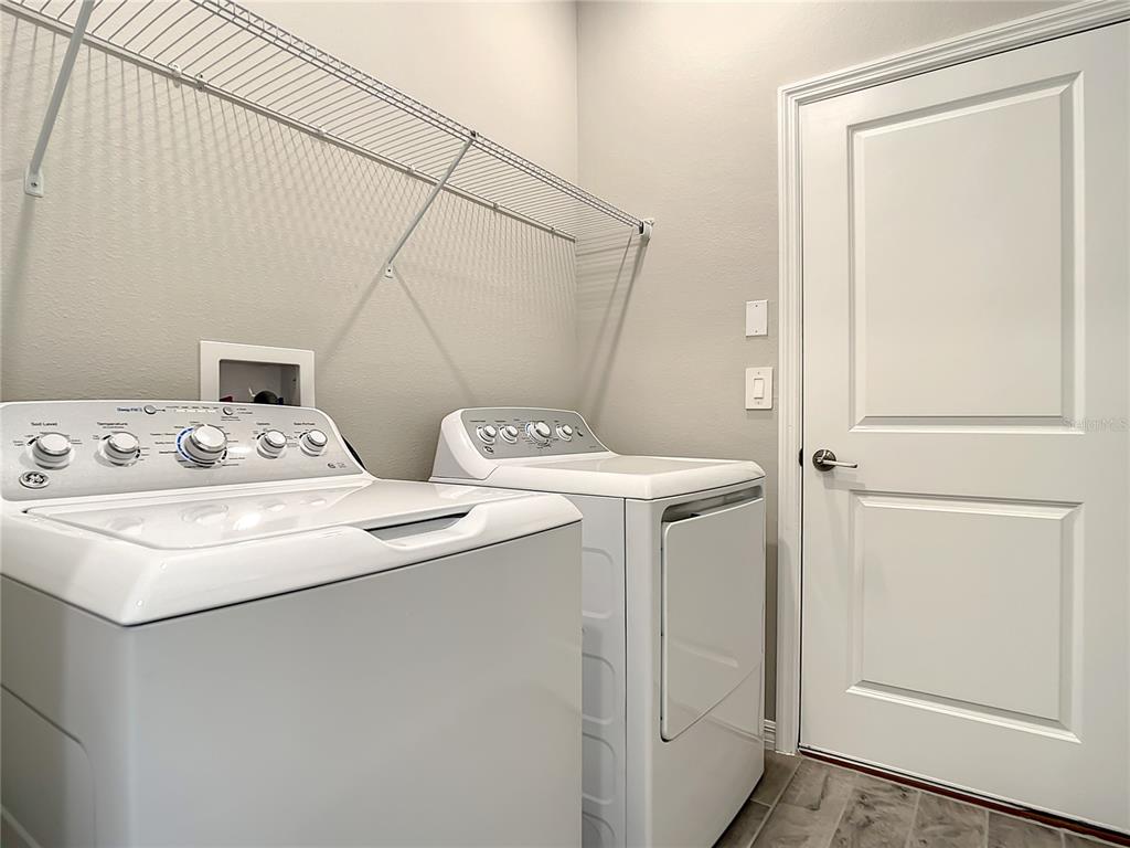 2675 Ridgetop Lane Clermont, FL 34711 - Photo 51 of 56 a utility room with dryer and washer