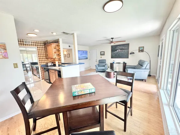 a view of a dining room with furniture and wooden floor