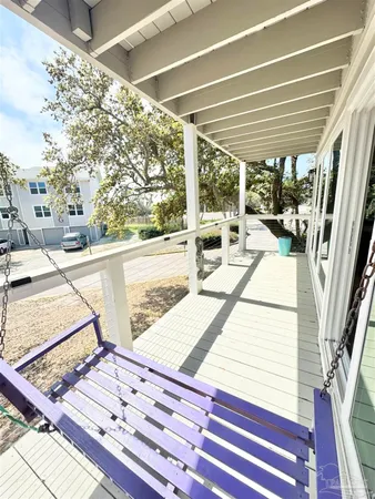 a view of a balcony with floor to ceiling windows with wooden floor