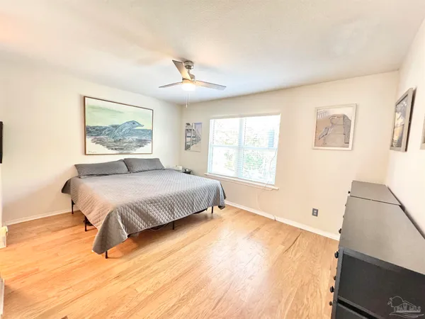 a bedroom with a bed and a painting on the wall