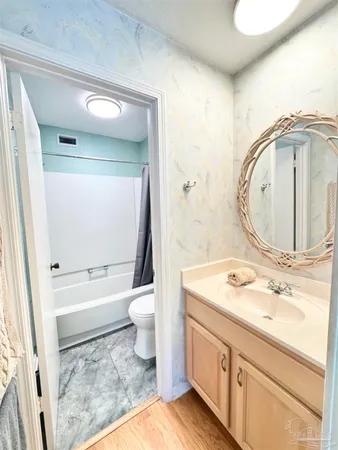 a bathroom with a sink a toilet and a mirror