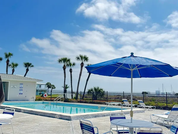 an outdoor space with furniture and umbrella
