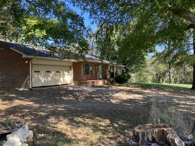 a view of a house with a yard and garage