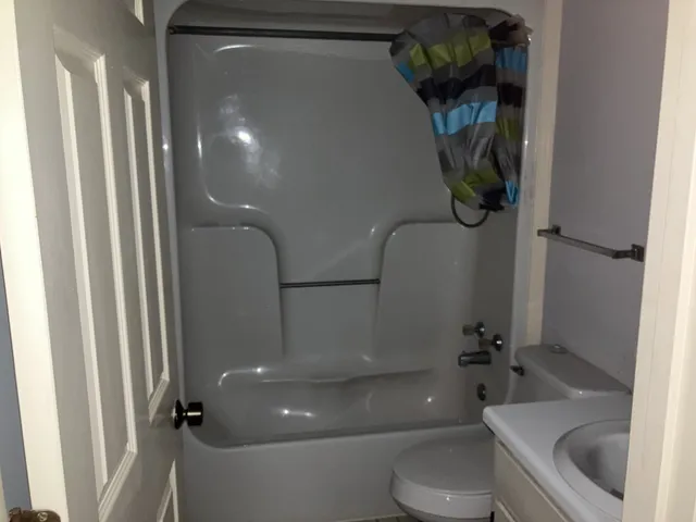 a bathroom with a toilet and a shower