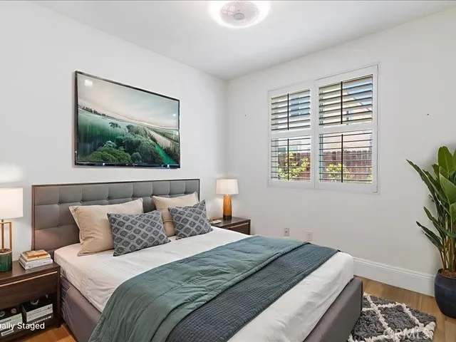 a bedroom with a bed and a painting on the wall