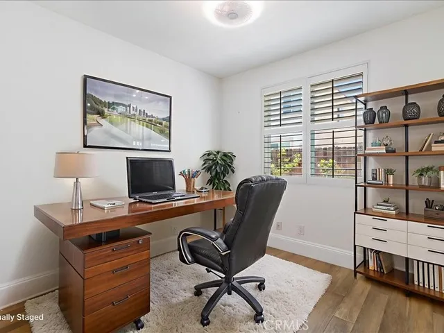 a bathroom with a granite countertop shower sink vanity and mirror