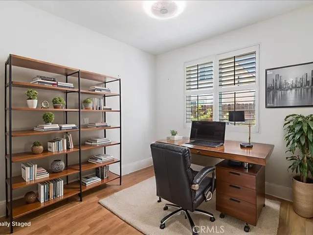 a view of a hallway with wooden floor and entryway