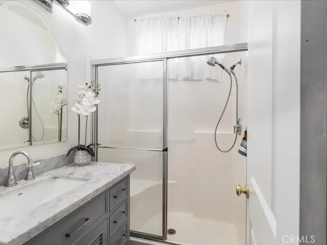 a spacious bedroom with a bed and a chandelier