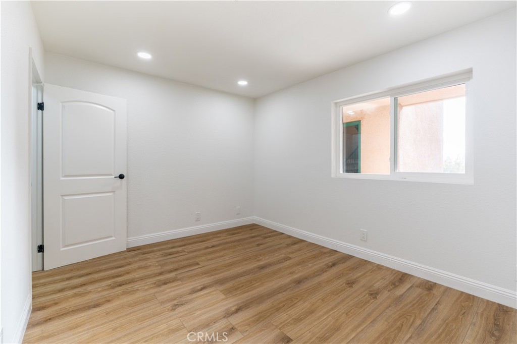 450 East 4th Street, Unit 237 Santa Ana, CA 92701 - Photo 14 of 25 wooden floor in an empty room with a window