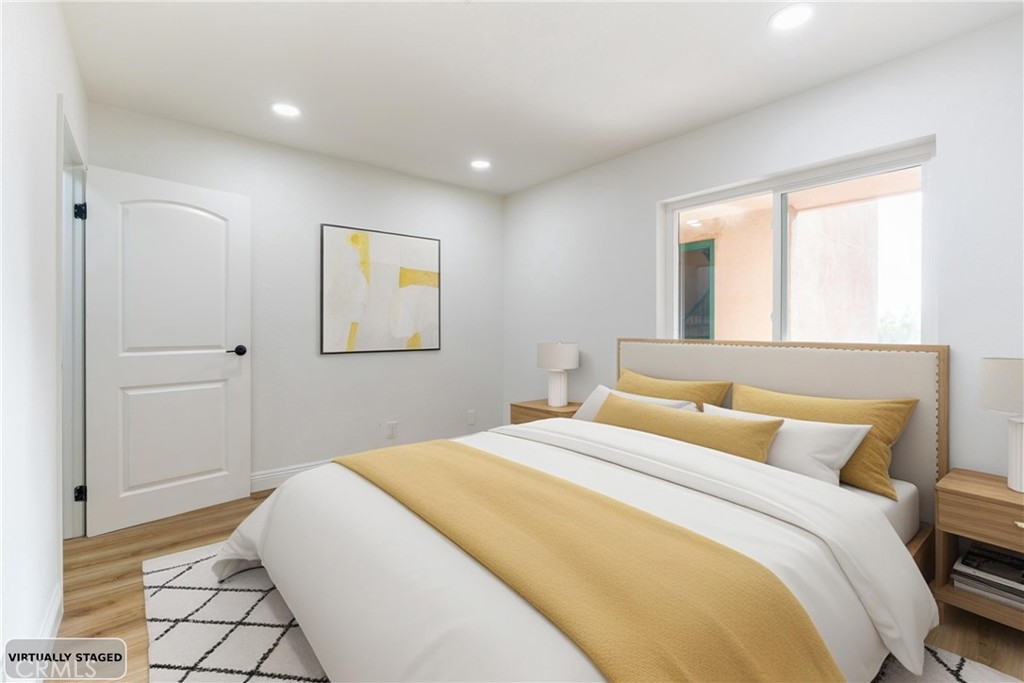 450 East 4th Street, Unit 237 Santa Ana, CA 92701 - Photo 15 of 25 a bedroom with a bed and a painting on the wall