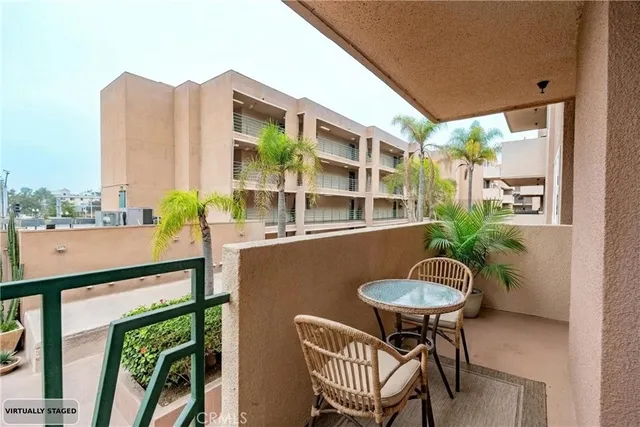 a view of a balcony with table and chairs