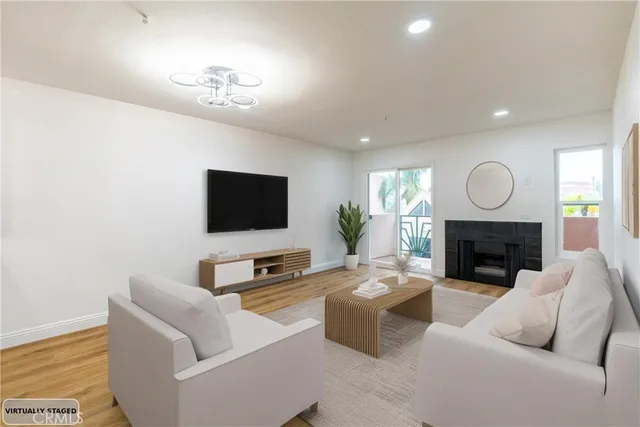 a living room with furniture a fireplace and a flat screen tv