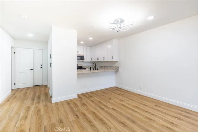 a view of a kitchen with wooden floor
