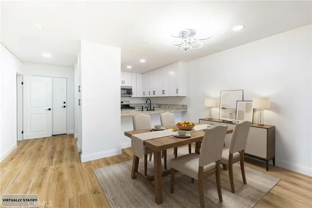 a view of a dining room with furniture and wooden floor