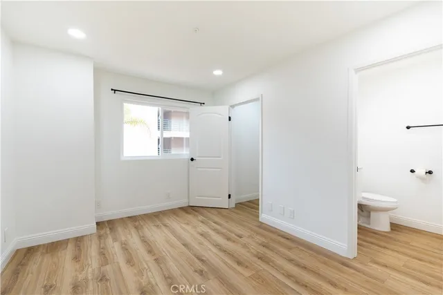 a view of a room with wooden floor and a sink