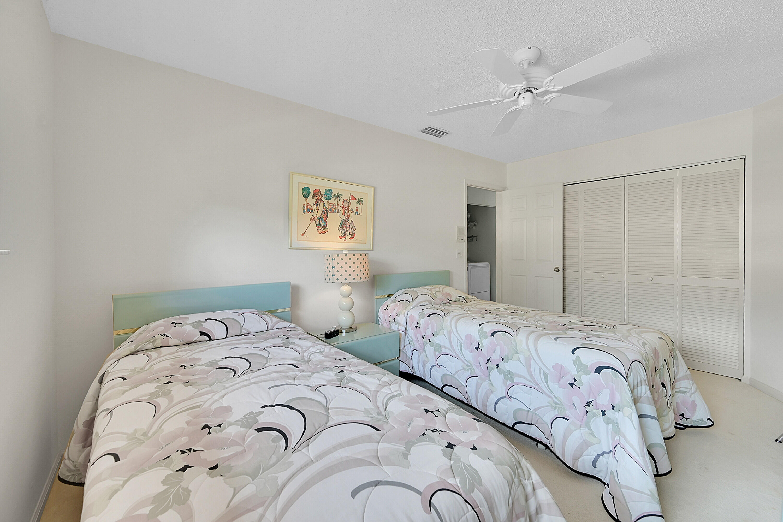 17270 Boca Club Boulevard, Unit 1702 Boca Raton, FL 33487 - Photo 24 of 41 a bedroom with two beds and a chandelier