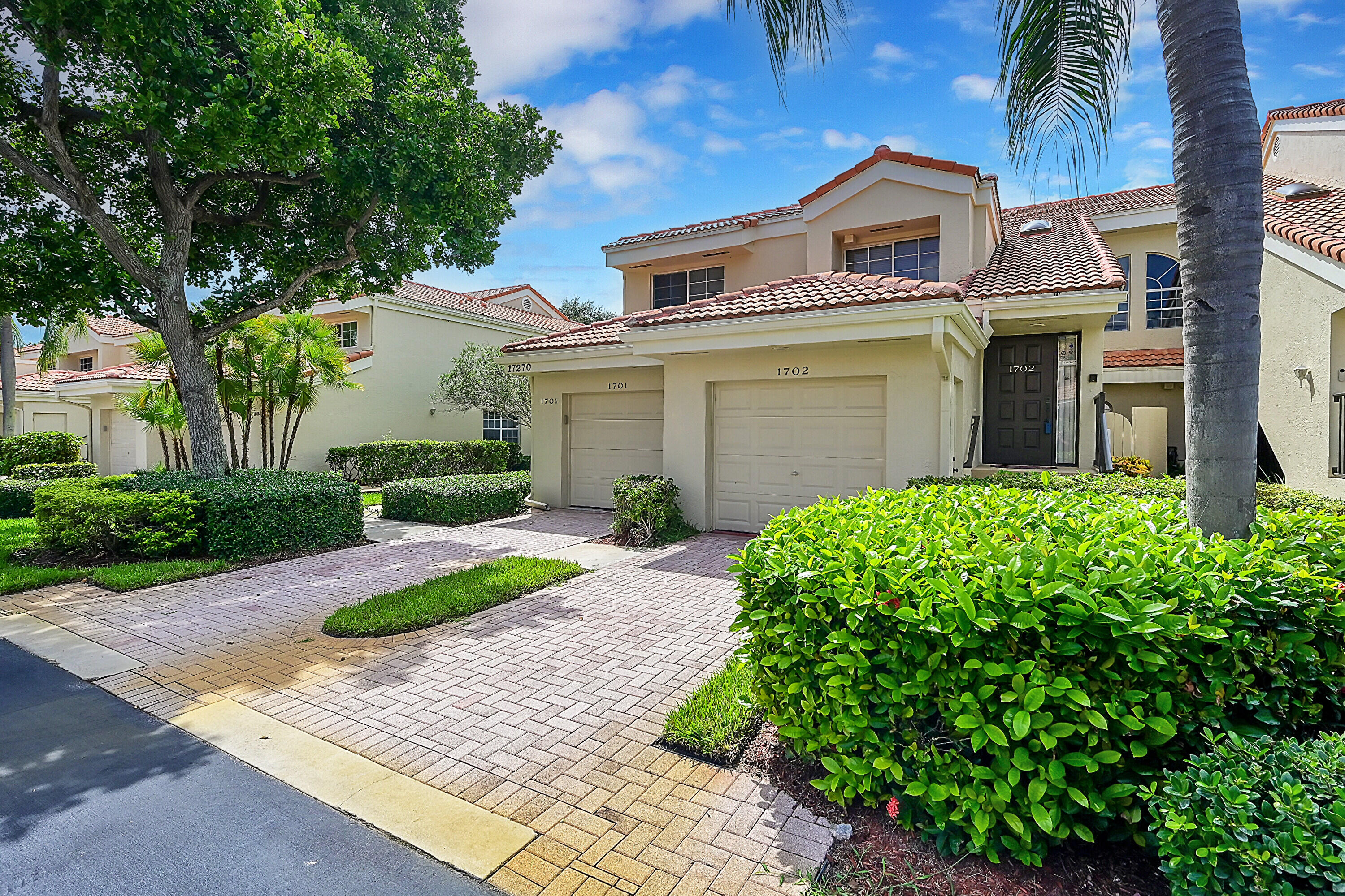 17270 Boca Club Boulevard, Unit 1702 Boca Raton, FL 33487 - Photo 3 of 41 a front view of a house with garden