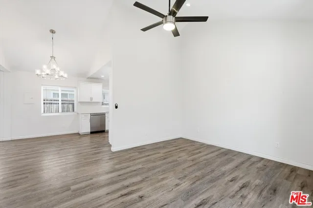 a view of a kitchen with wooden floor and a window