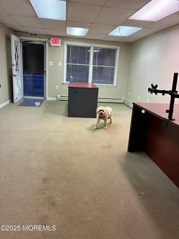 an empty room with furniture and windows