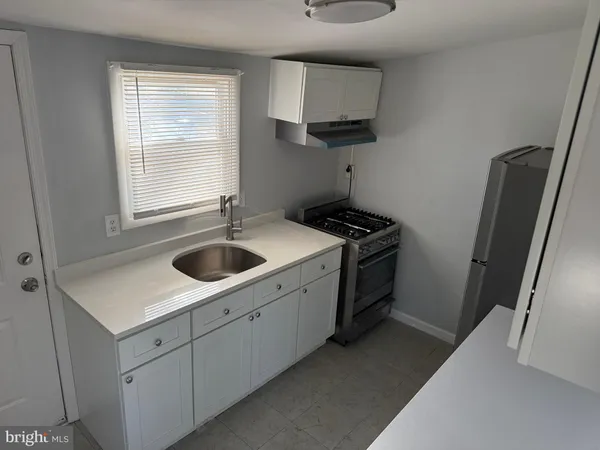 a kitchen with a sink dishwasher a washer and dryer