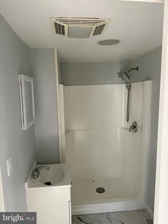a bathroom with a shower and toilet