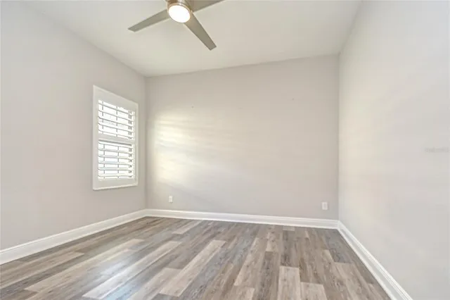 an empty room with a empty space and a ceiling fan