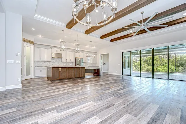 a kitchen with stainless steel appliances granite countertop a refrigerator and a stove top oven