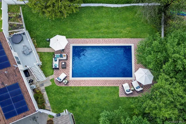a view of an house with backyard space and outdoor seating