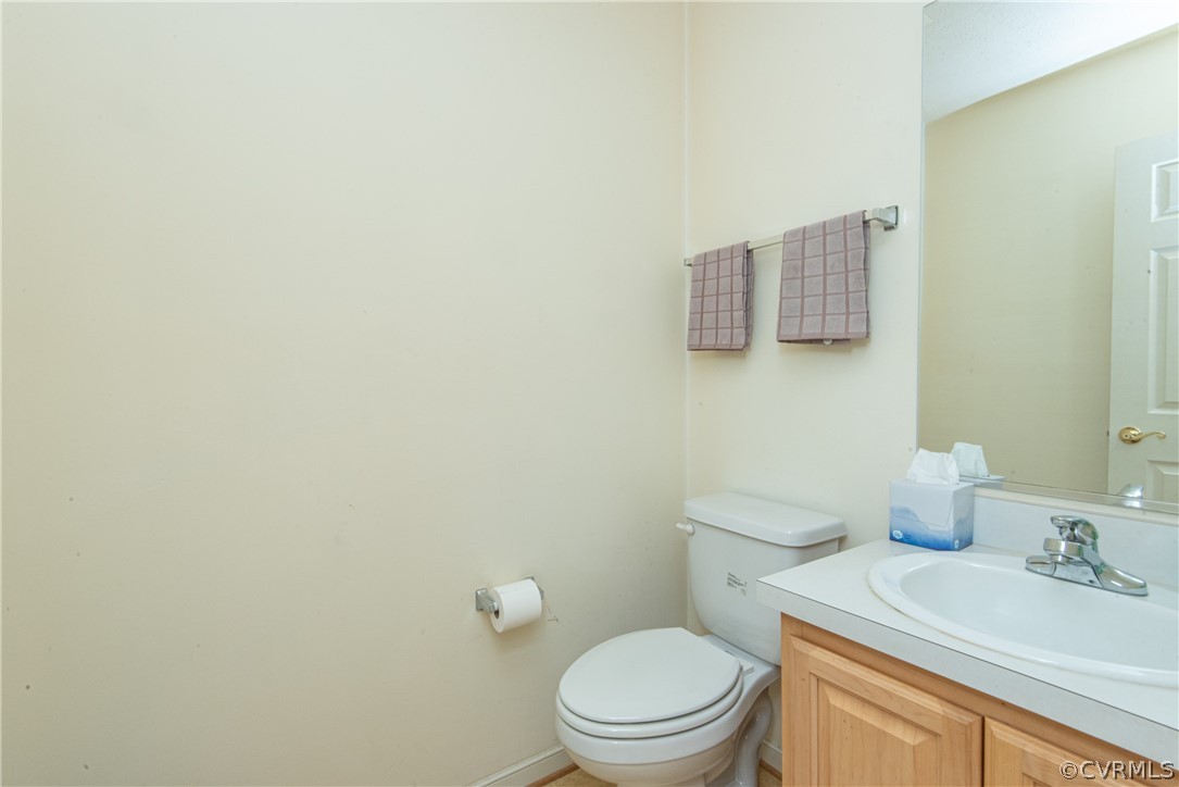 3327 Stone Manor Circle, Unit 9B Chester, VA 23831 - Photo 12 of 27 a bathroom with a toilet sink vanity and mirror