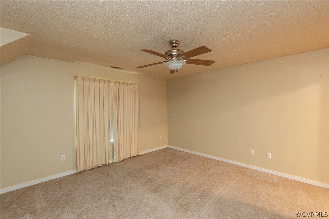 3327 Stone Manor Circle, Unit 9B Chester, VA 23831 - Photo 14 of 27 an empty room with a ceiling fan and a window