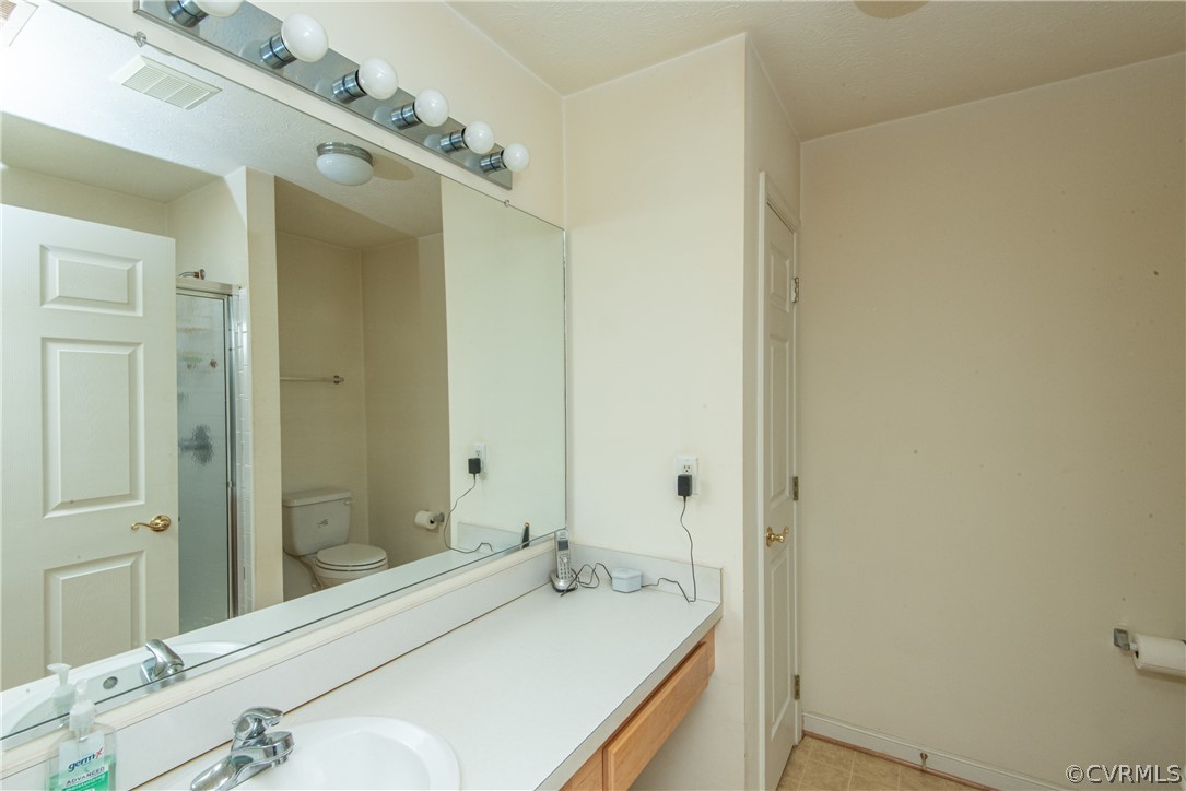 3327 Stone Manor Circle, Unit 9B Chester, VA 23831 - Photo 16 of 27 a bathroom with a sink and a mirror