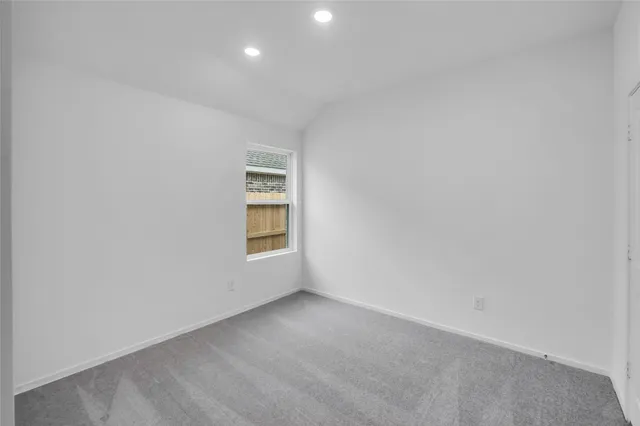 a view of an empty room and a window