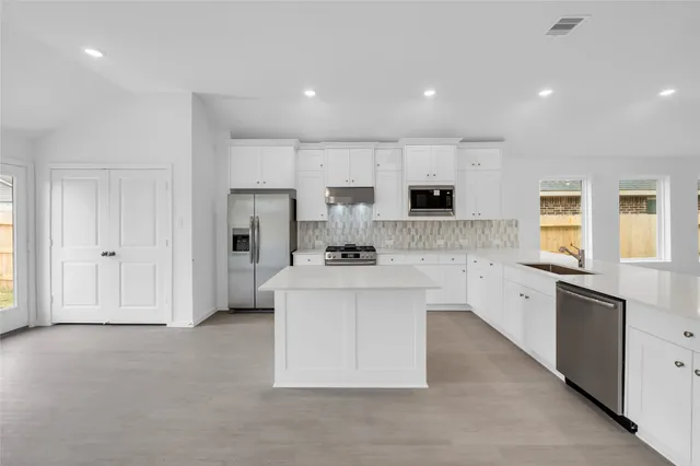a view of kitchen with sink microwave and refrigerator