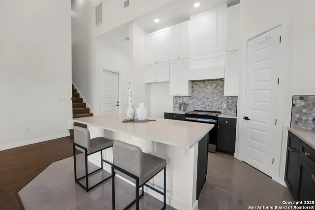 a kitchen with a stove a refrigerator and a dining table