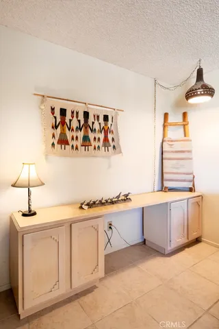 a view of a dining room with furniture and a chandelier