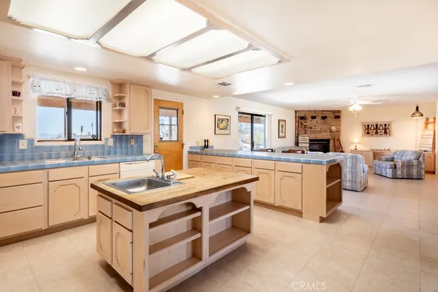 a kitchen with a stove a refrigerator and a dining table