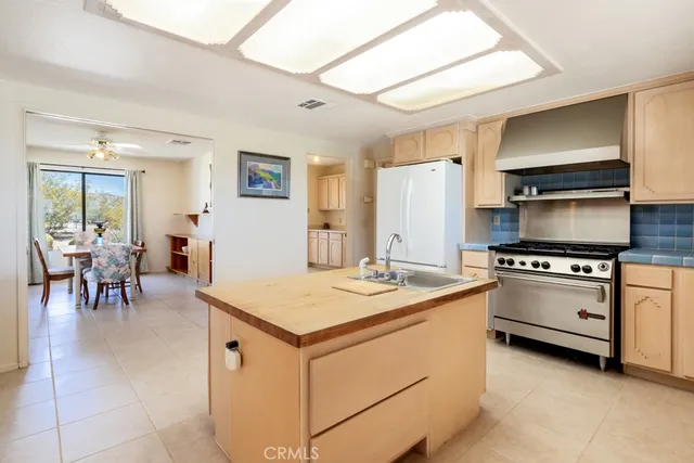 a view of a livingroom with a chandelier fan and a bathroom