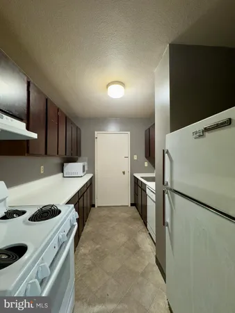 a kitchen with a stove and a refrigerator