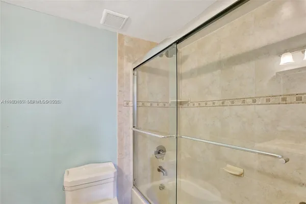 a bathroom with a shower and a toilet