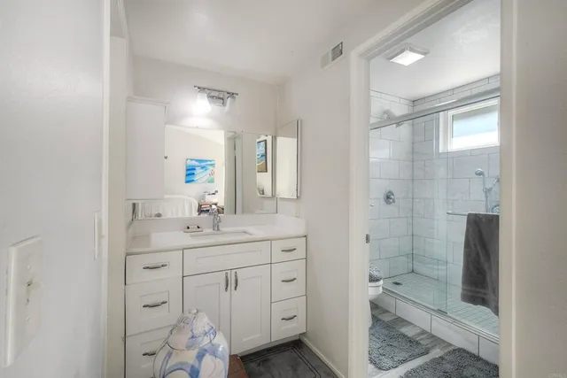 a bedroom with a bed a couch and dresser