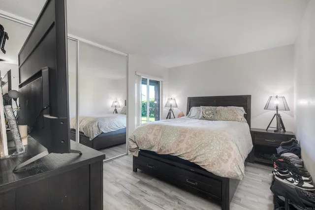 a bed sitting in a bedroom next to a window