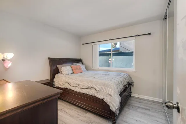 a bed sitting in a bedroom next to a window