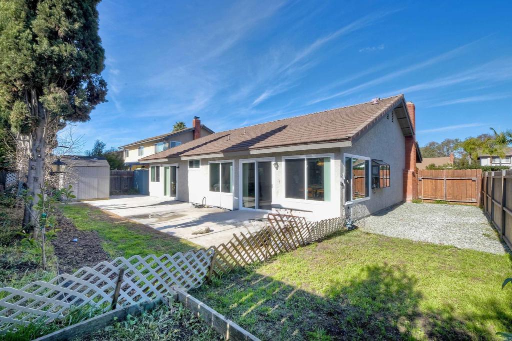 4413 Point Degada Oceanside, CA 92058 - Photo 16 of 31 a front view of a house with a yard table and chairs