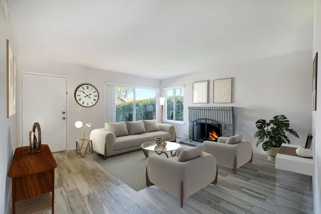 a living room with furniture potted plant and a fireplace
