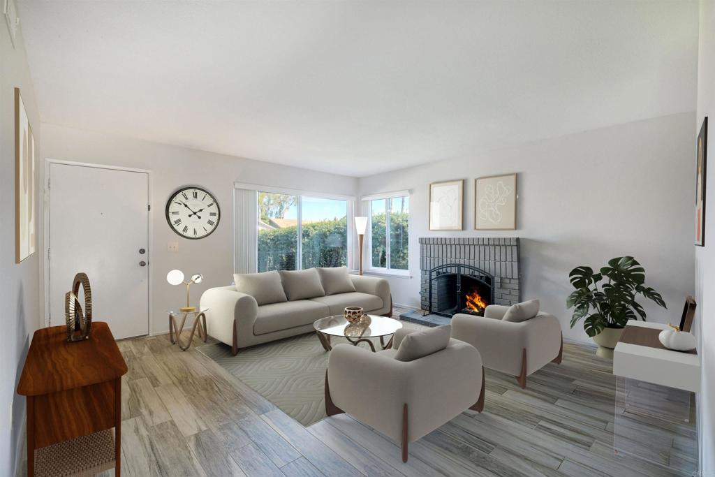 4413 Point Degada Oceanside, CA 92058 - Photo 4 of 31 a living room with furniture potted plant and a fireplace