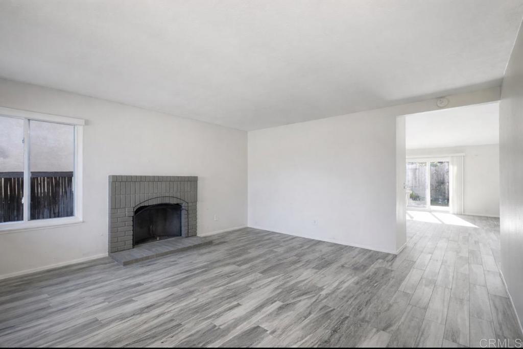 4413 Point Degada Oceanside, CA 92058 - Photo 5 of 31 a view of empty room with wooden floor and fireplace