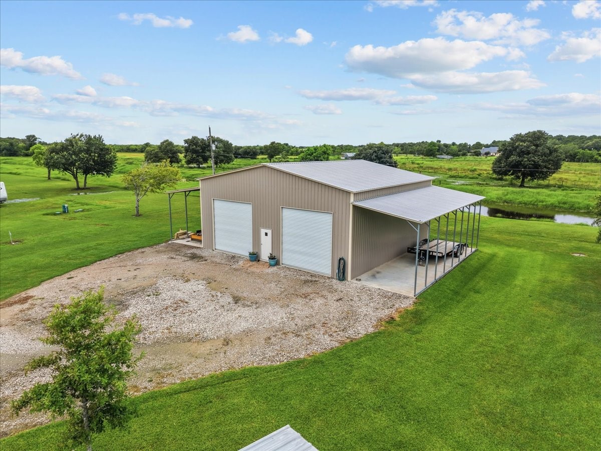 8710 Fm 646 Road South Santa Fe, TX 77510 - Photo 25 of 32 10x40 awnings on both sides provide excellent covered space for equipment, vehicles, trailers, or outdoor work areas